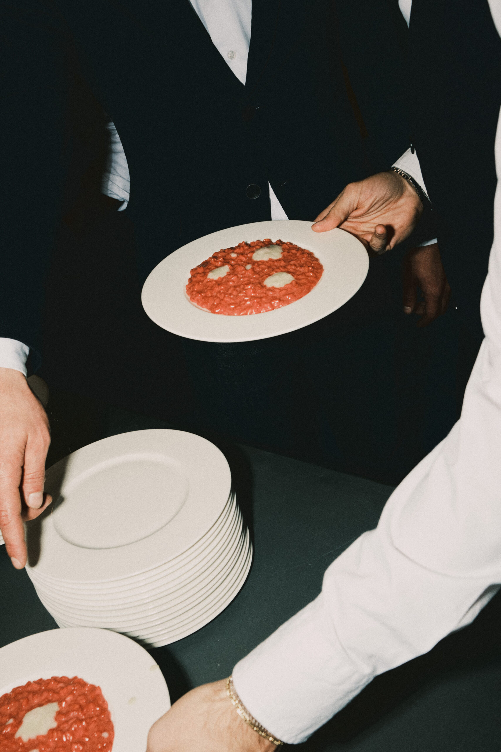Camerieri che tengono impiattano il risotto